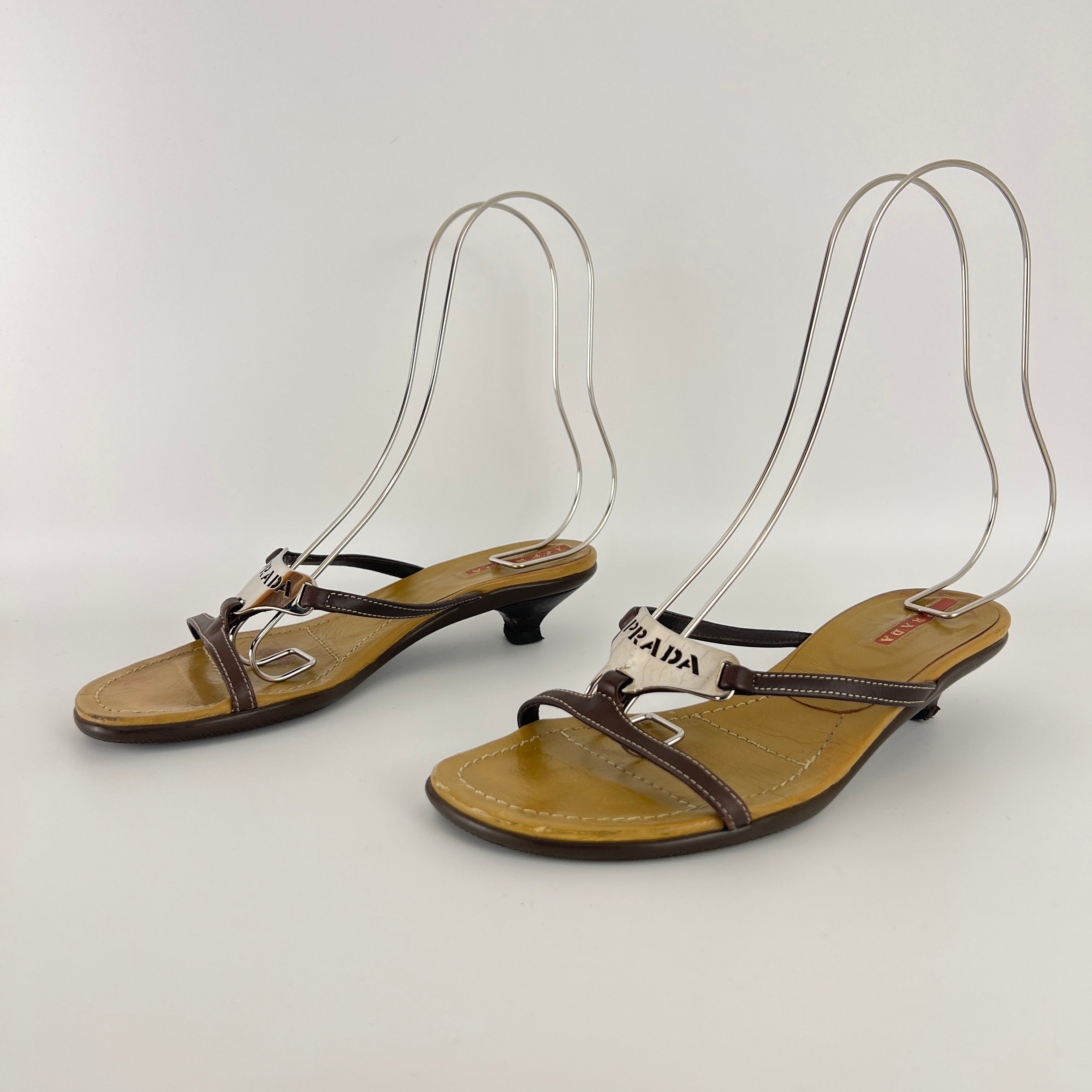 Prada | Brown Leather Silver Logo Buckle Kitten Sandal Heels (34.5)