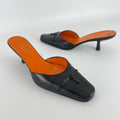 Gucci | Black Leather Closed Toe Brogue Tassel Orange Insole Mules (37C)