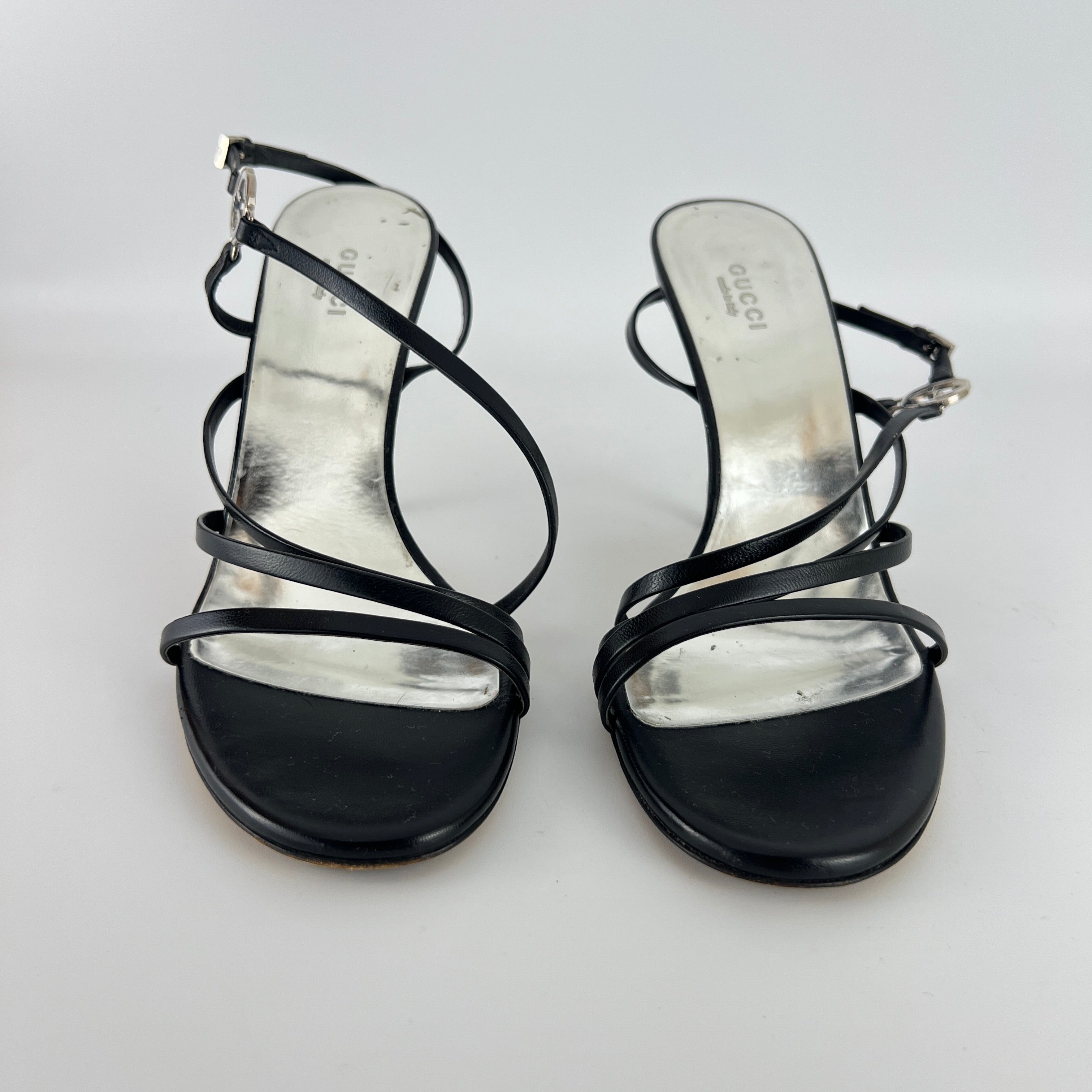 Gucci | GG Logo Silver Hardware Black Leather Metallic Insole Strappy Heels (37.5)