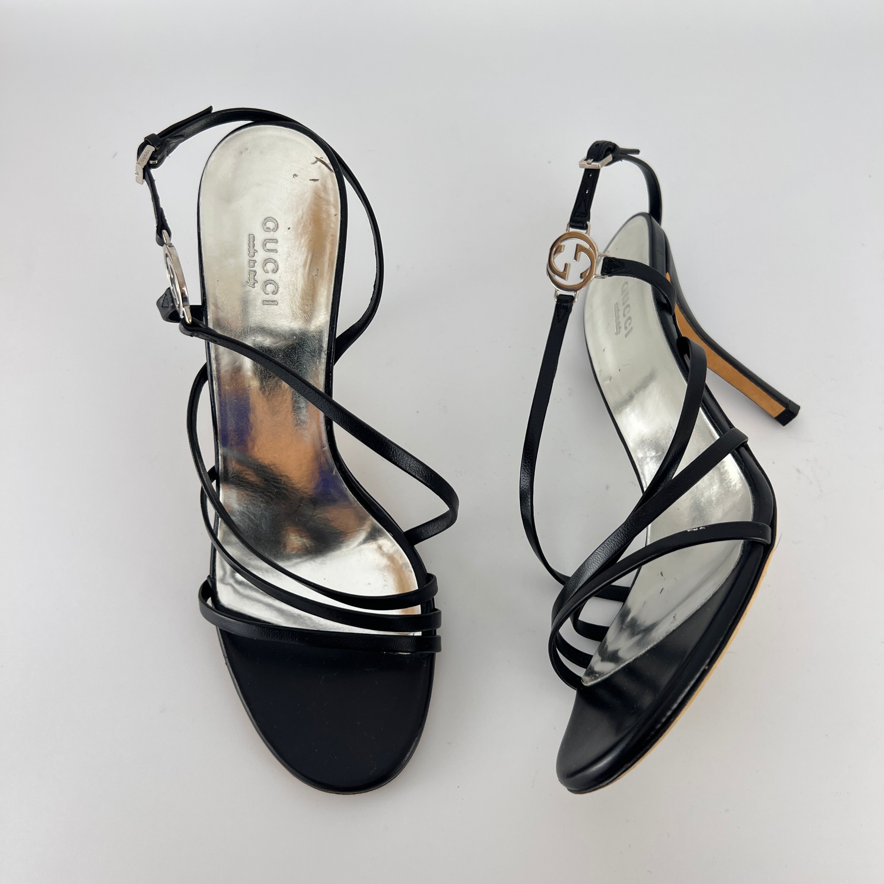 Gucci | GG Logo Silver Hardware Black Leather Metallic Insole Strappy Heels (37.5)