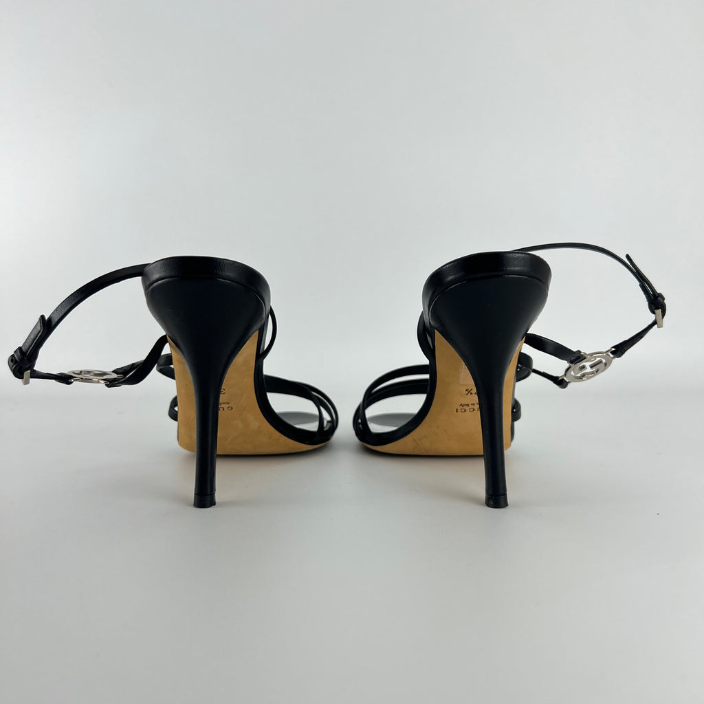 Gucci | GG Logo Silver Hardware Black Leather Metallic Insole Strappy Heels (37.5)