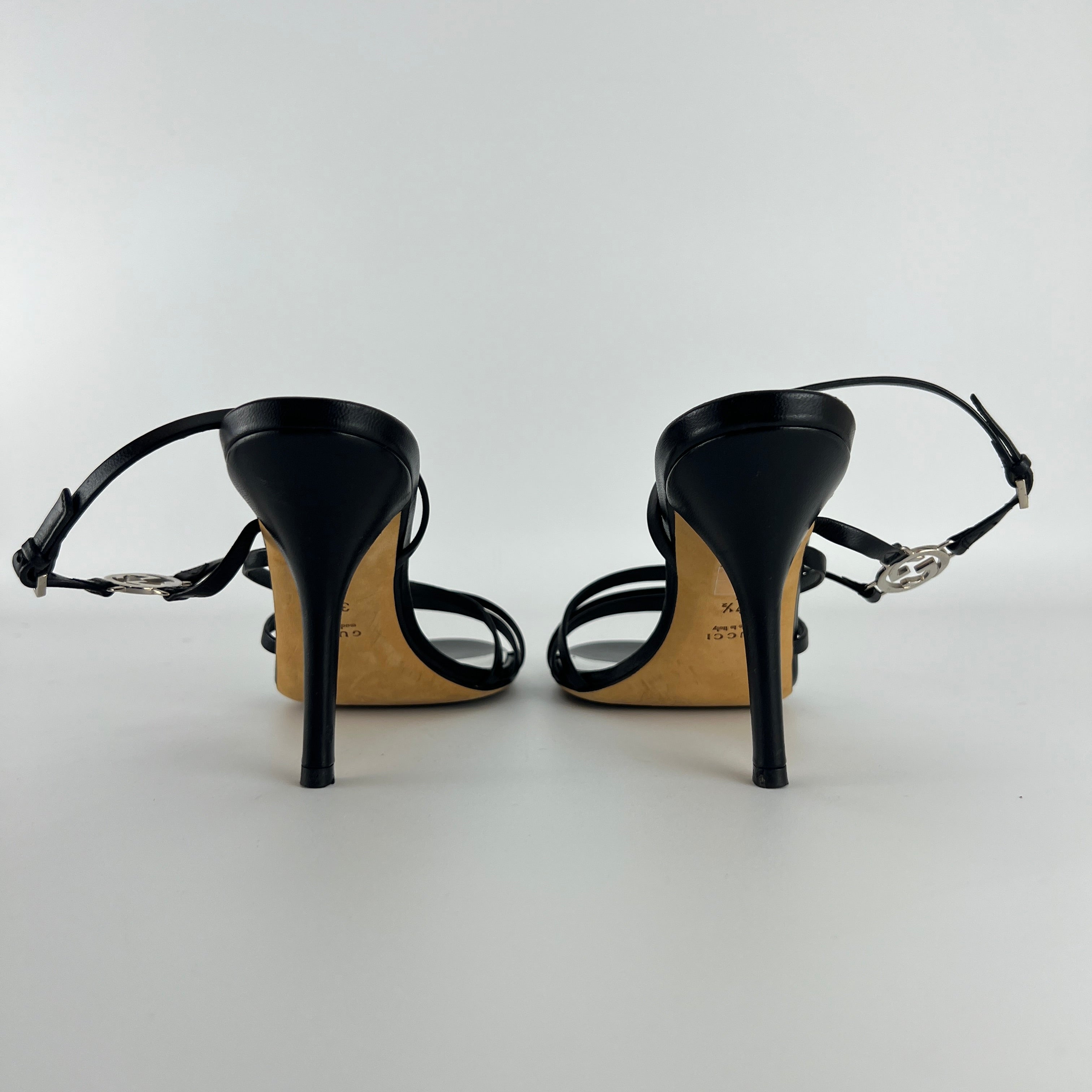 Gucci | GG Logo Silver Hardware Black Leather Metallic Insole Strappy Heels (37.5)