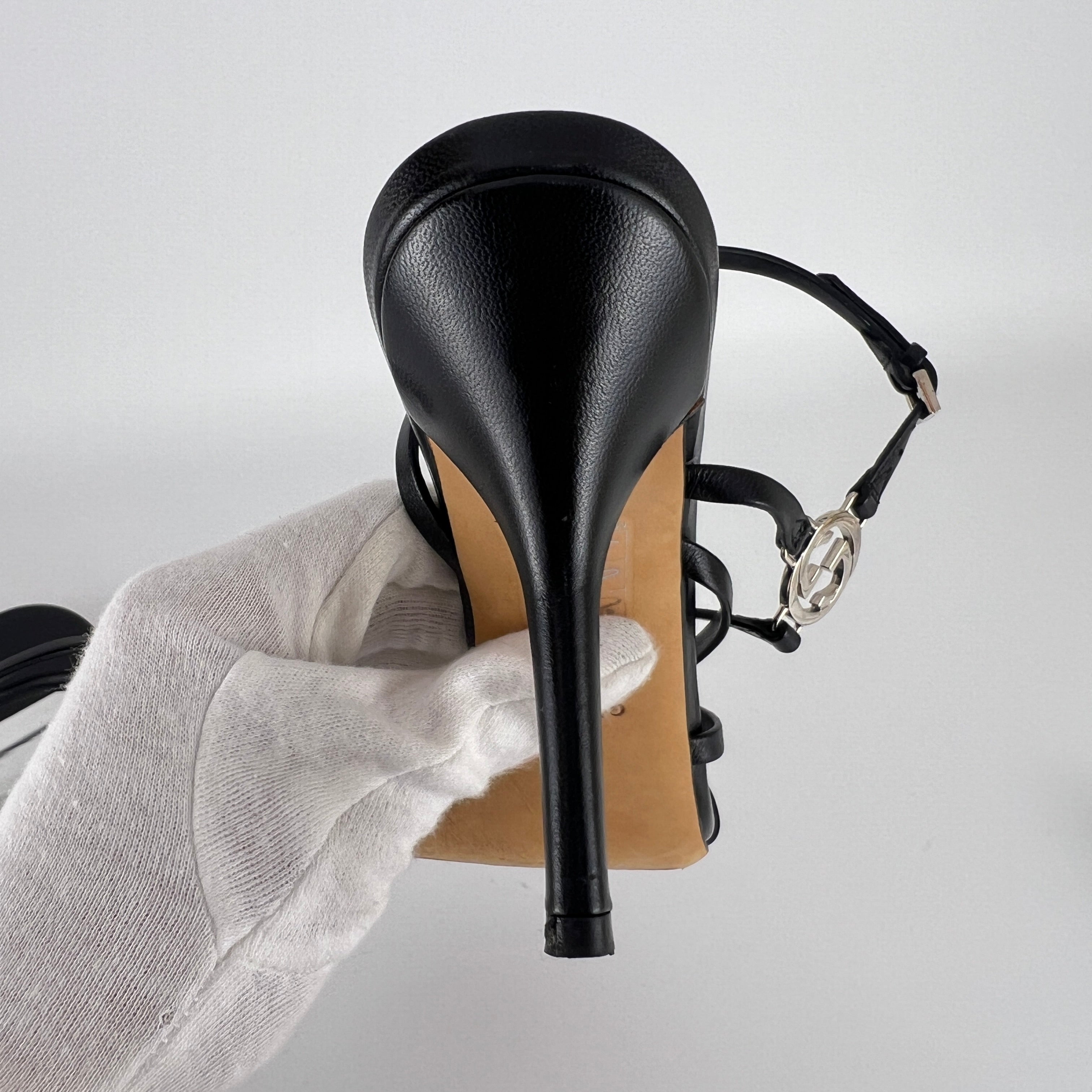 Gucci | GG Logo Silver Hardware Black Leather Metallic Insole Strappy Heels (37.5)