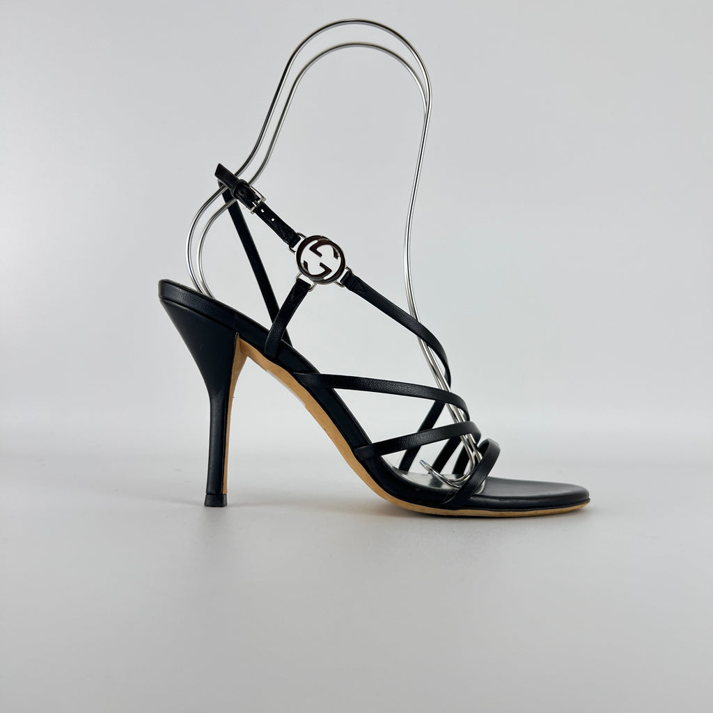 Gucci | GG Logo Silver Hardware Black Leather Metallic Insole Strappy Heels (37.5)