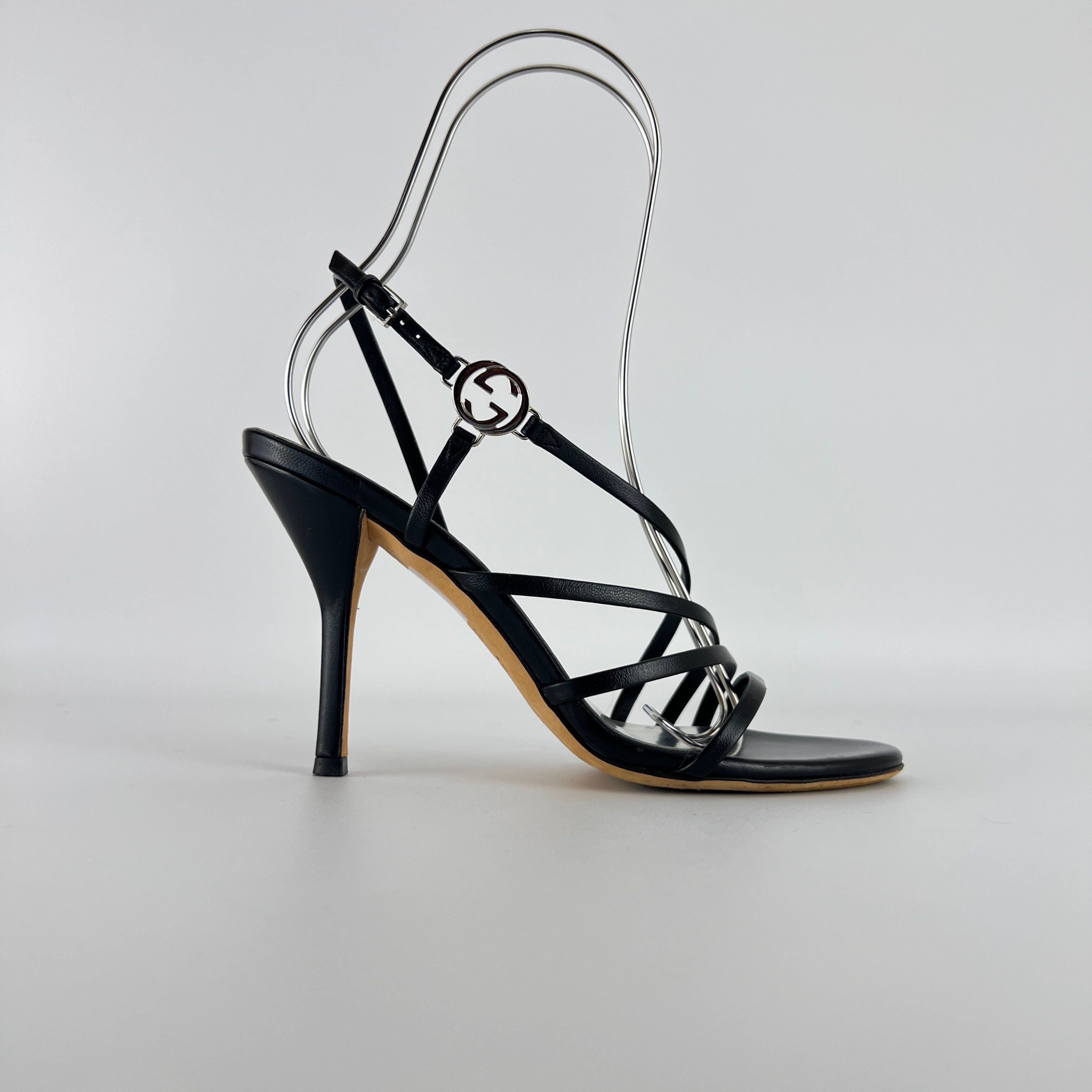 Gucci | GG Logo Silver Hardware Black Leather Metallic Insole Strappy Heels (37.5)
