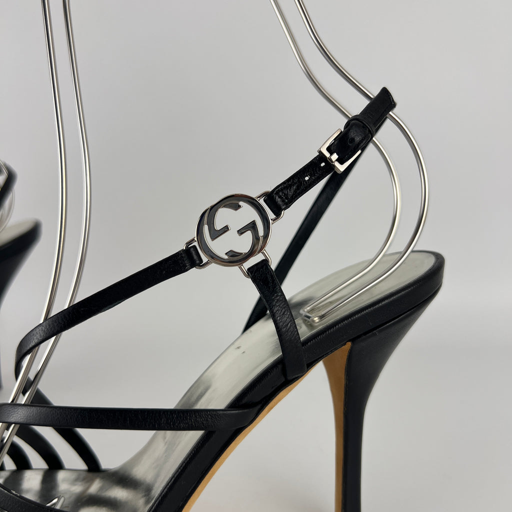 Gucci | GG Logo Silver Hardware Black Leather Metallic Insole Strappy Heels (37.5)