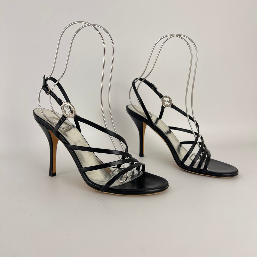Gucci | GG Logo Silver Hardware Black Leather Metallic Insole Strappy Heels (37.5)