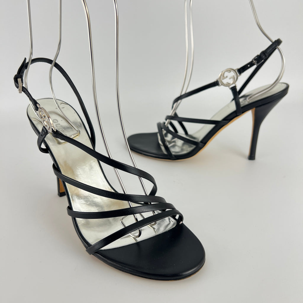 Gucci | GG Logo Silver Hardware Black Leather Metallic Insole Strappy Heels (37.5)
