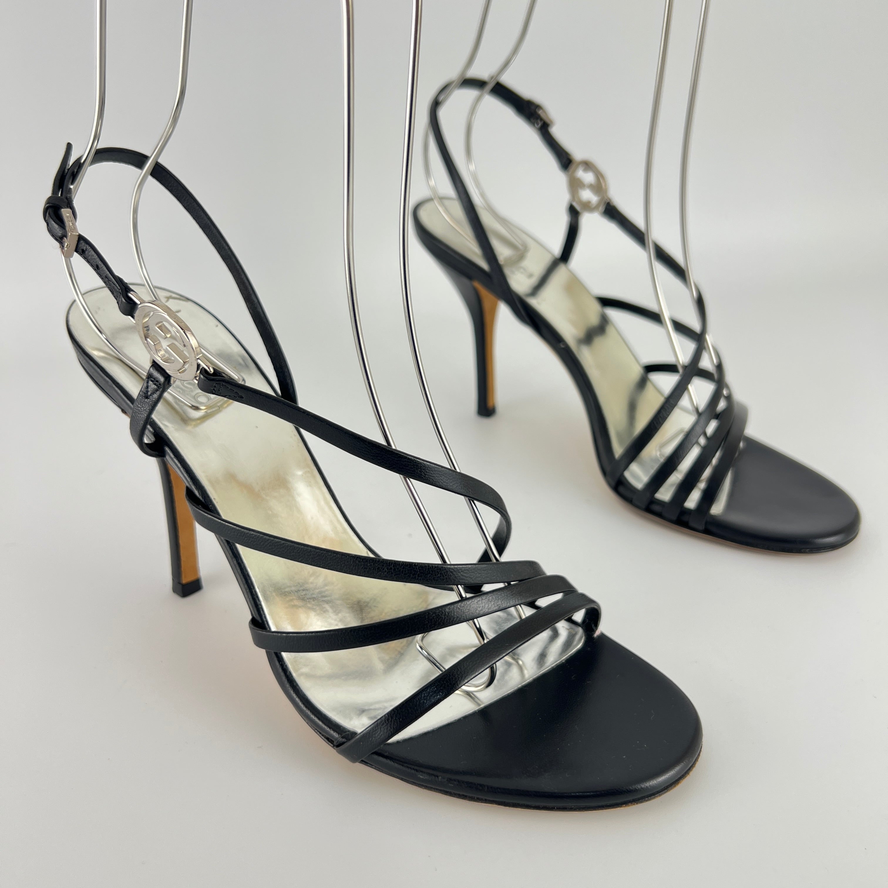 Gucci | GG Logo Silver Hardware Black Leather Metallic Insole Strappy Heels (37.5)