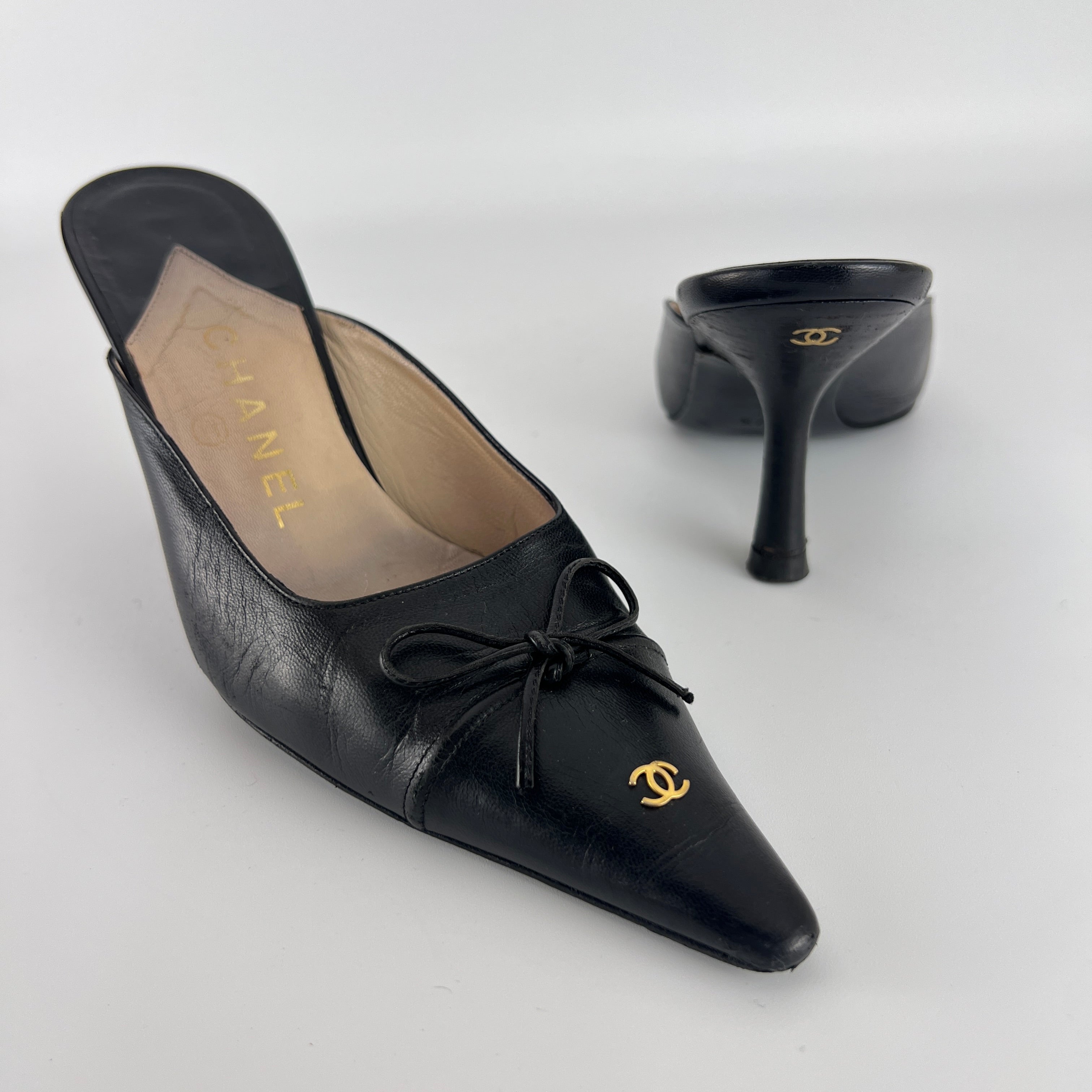 Chanel | Vintage Black Leather CC Logo Bow Pointed Toe Slide Mules (37.5)