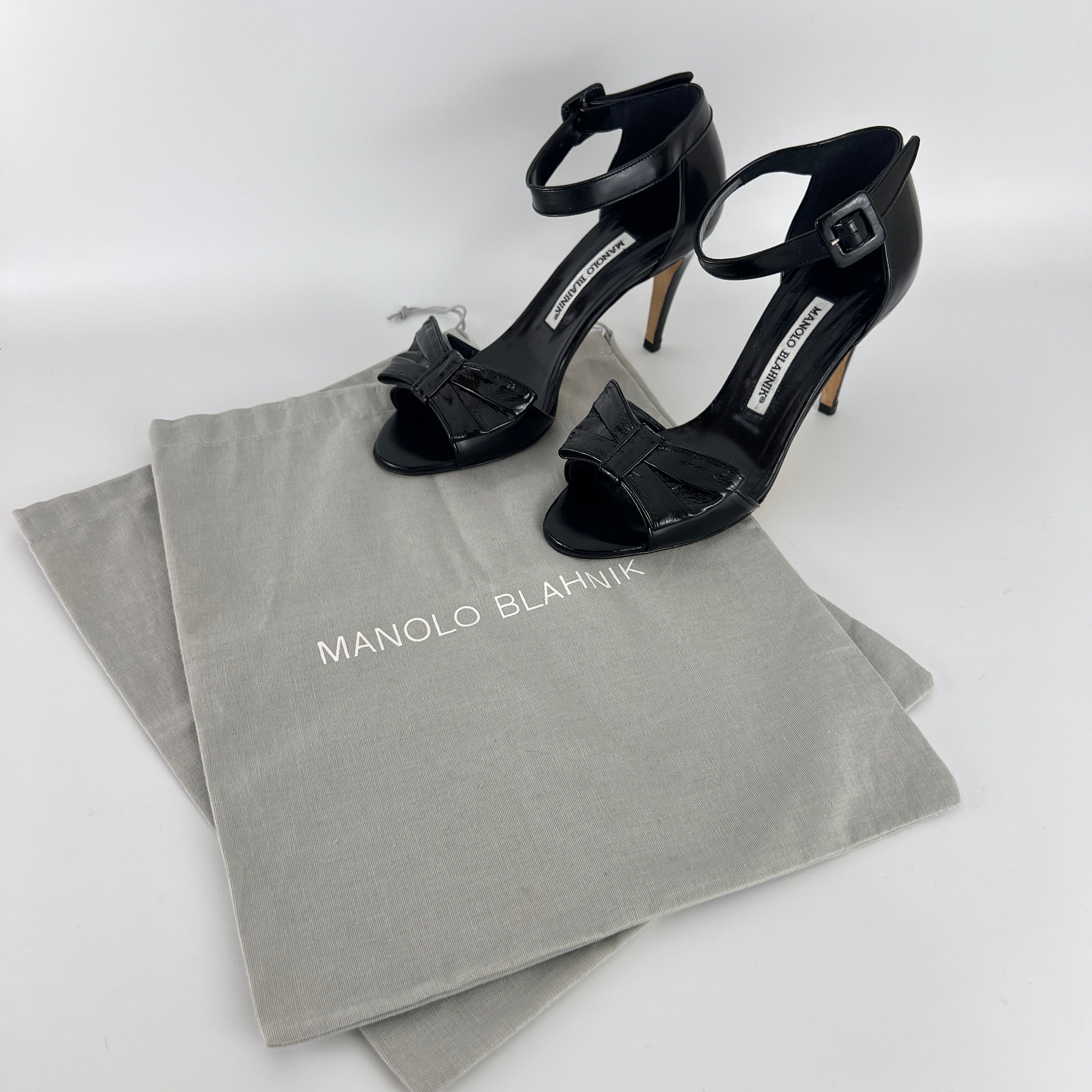 Manolo Blahnik | Black Patent Leather Bow Ankle Wrap Sandal Heels (36.5)