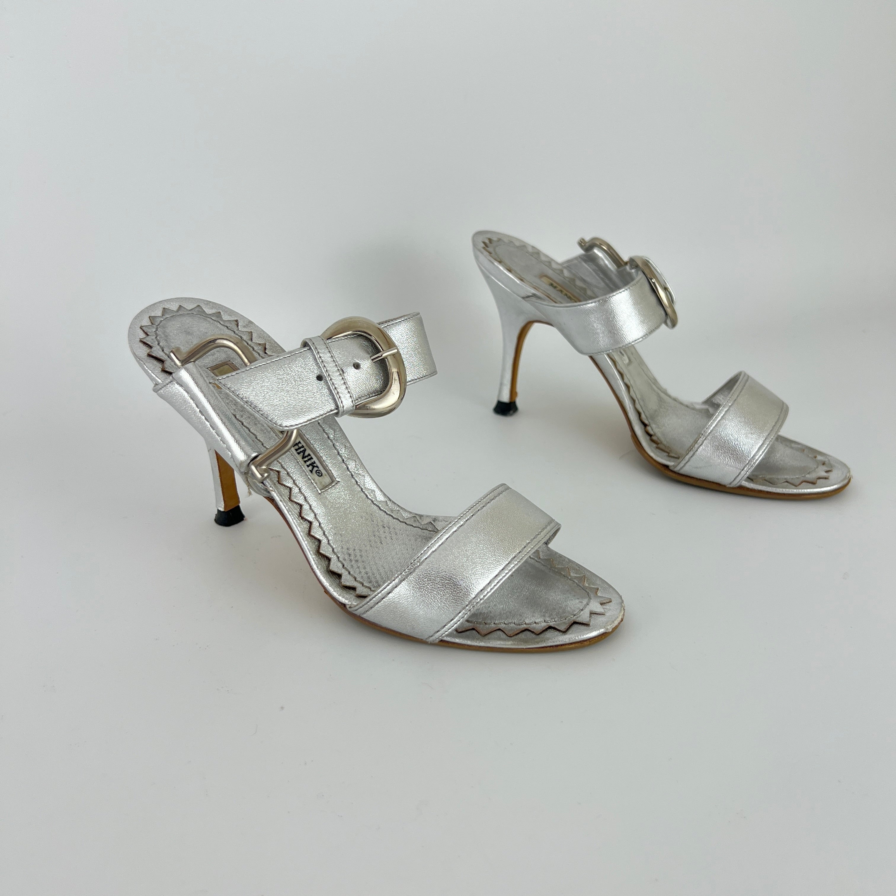 Manolo Blahnik | Metallic Silver Buckle Horsebit Detail Dual Strap Mules (34.5)